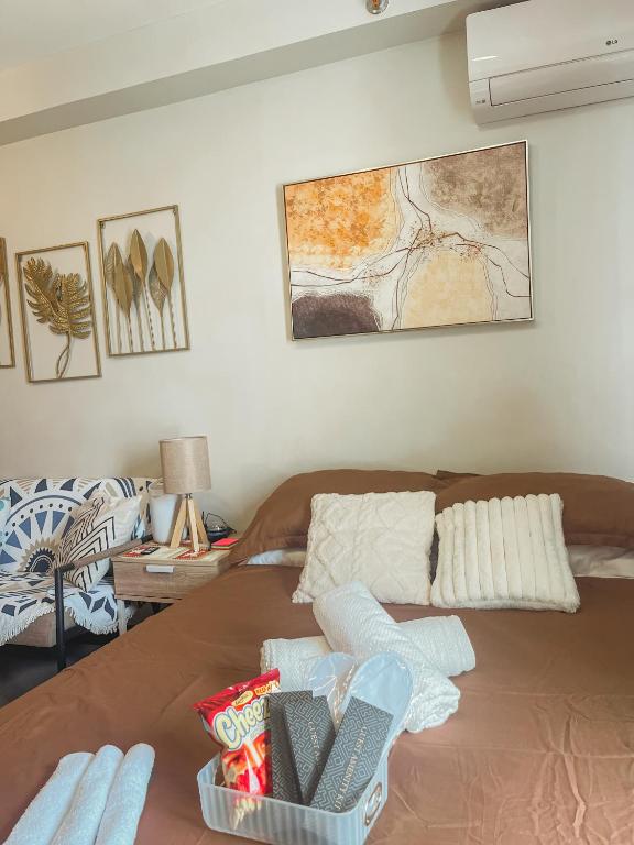 a living room with a bed and a couch at Gold-Themed Condo with Balcony and FREE Pool Access in Suba