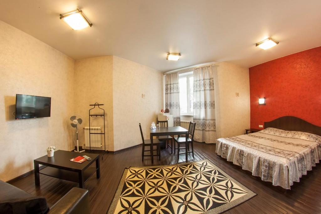 a hotel room with a bed and a table at Red Hotel in Novosibirsk