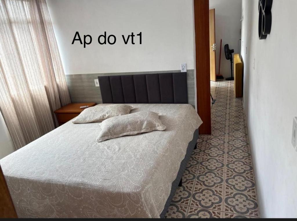 a bedroom with a bed with two pillows on it at Pouso amigo do Vt 2 in Paracambi