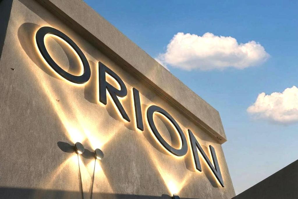 a building with the sign for the entrance to a store at Orion Eco Suites in Karteros