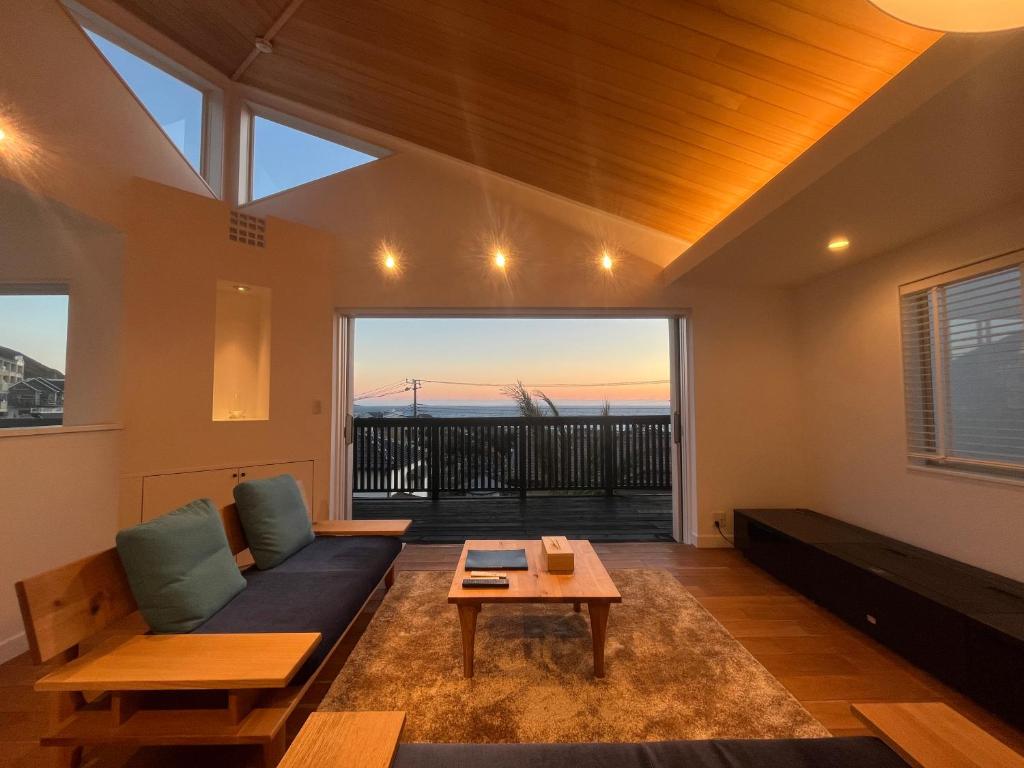 a living room with a couch and a table at Smile House Akiya in Hayama