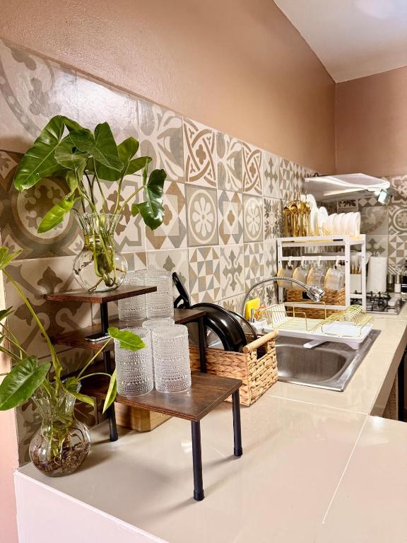 a kitchen with a sink and a table with plants at Casa Zapata in Chano