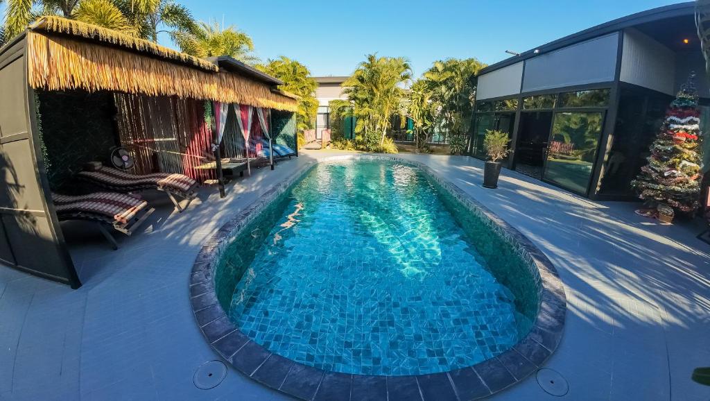 a swimming pool in the middle of a house at The Longhouse Luxury Boutique Resort in Sakon Nakhon