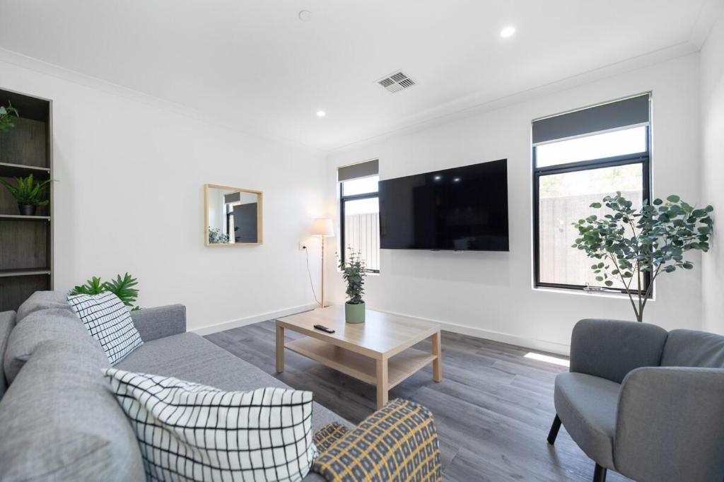 a living room with a couch and a table at Winchester Residence in Armadale