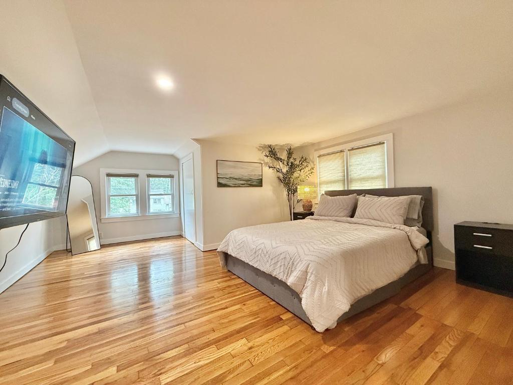 a bedroom with a large bed and a flat screen tv at North Haven Rooms in North Haven