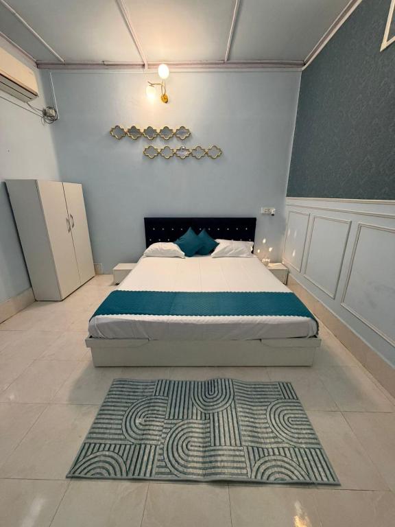 a bedroom with a bed and a rug at Vina Homestay in Jorhat