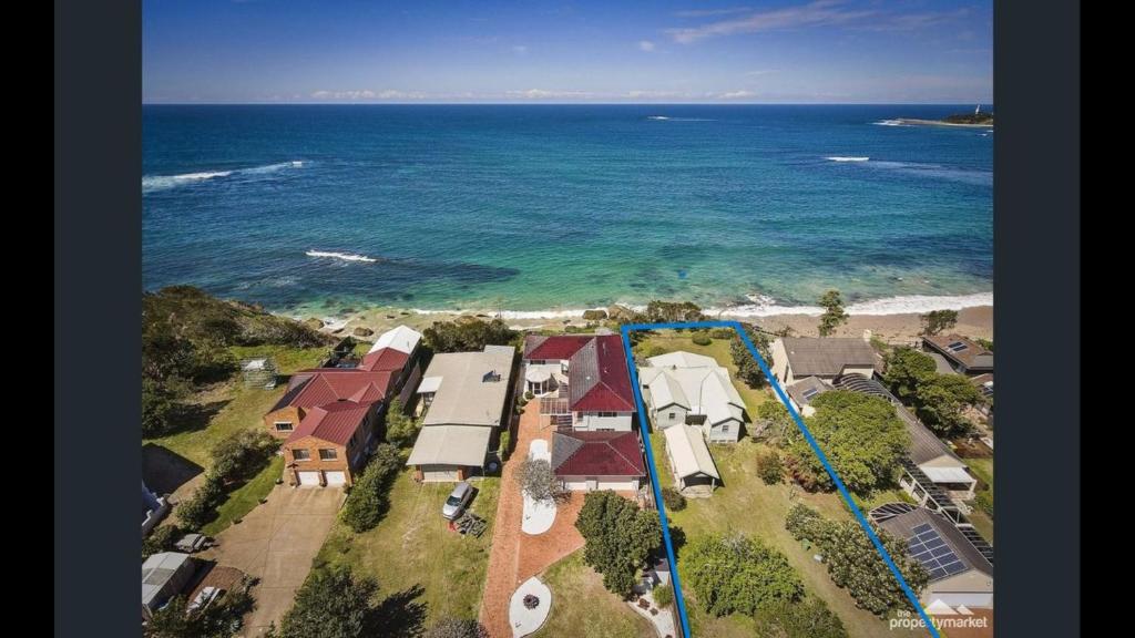 an aerial view of a house by the ocean at Cliff Cottage - Noraville in Norah