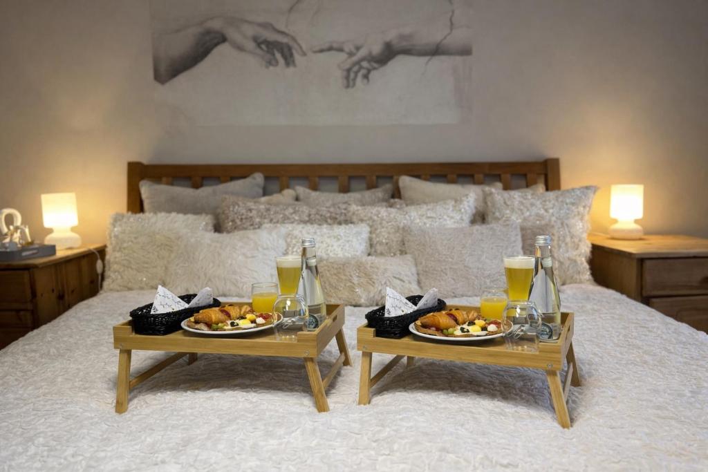 two tables with plates of food on a bed at Vital House in Kazimierz Dolny