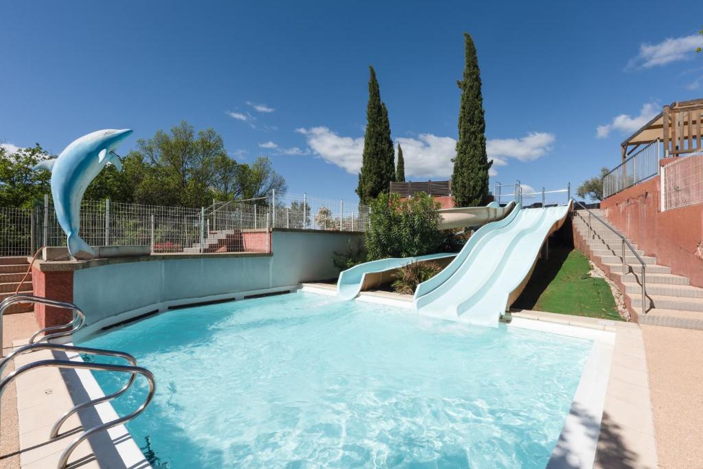 a water slide with a dolphin on it at Chez gaby in Lagorce