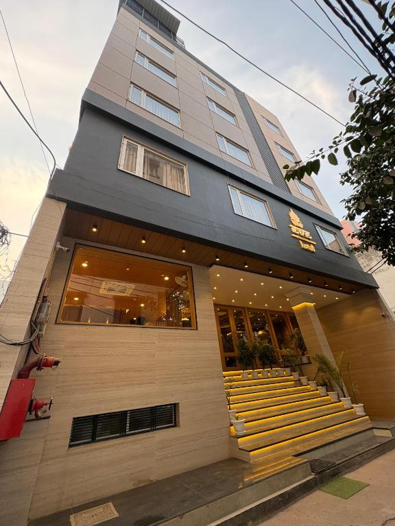 a building with stairs in front of a building at Eve Hotel in Varanasi