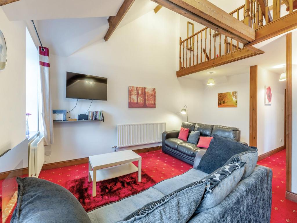 a living room with a couch and a table at The Old Drapery - Uk43568 in Haltwhistle