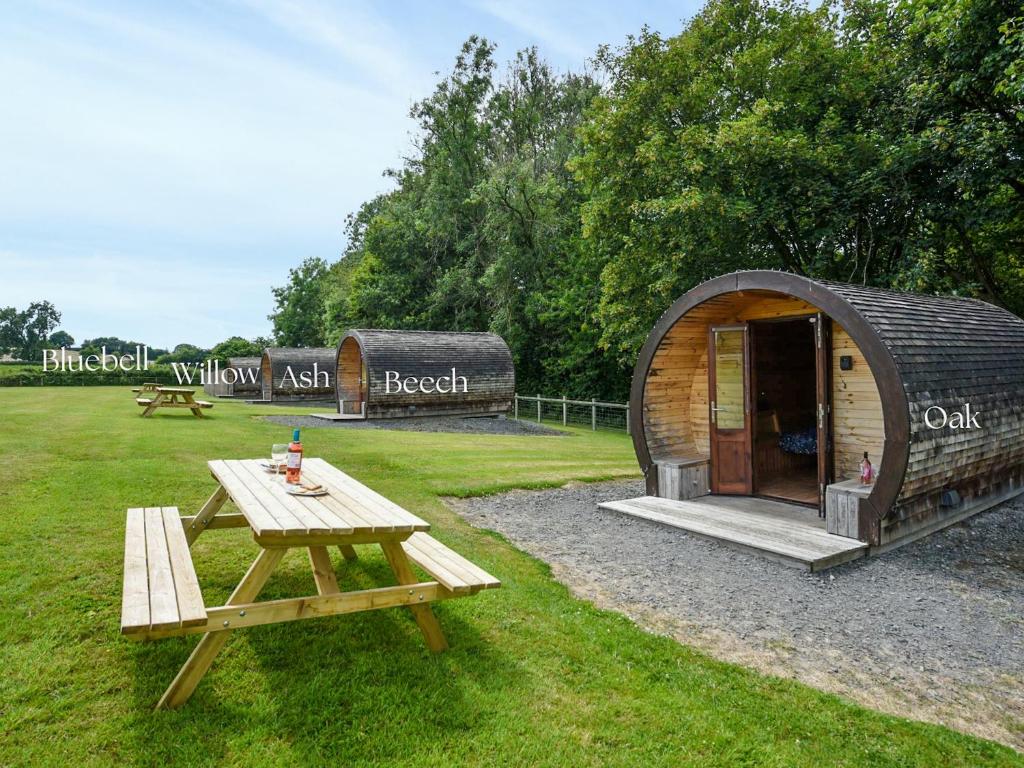a small tent and a picnic table in a field at Oak - Glamping Pod - Uk49946 in Oswestry