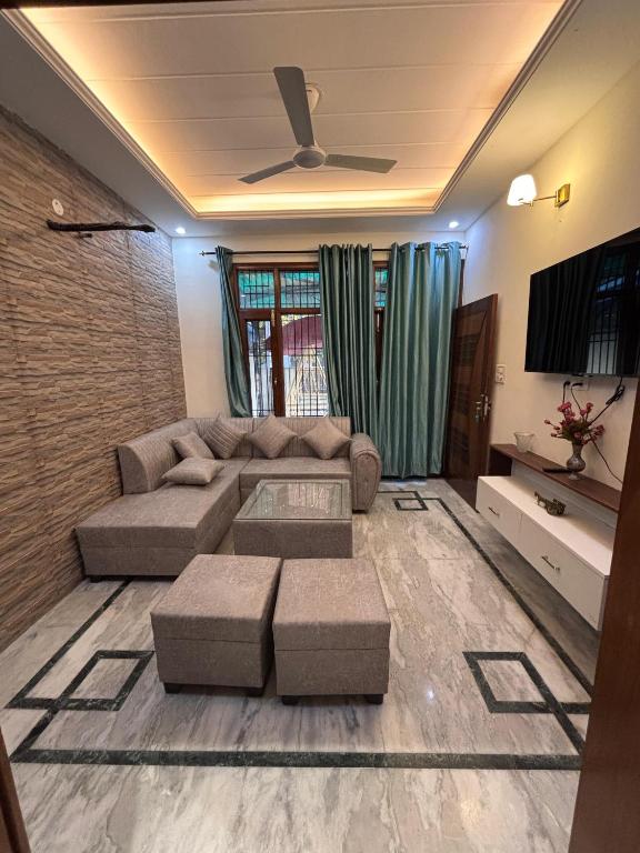 a living room with a couch and a tv at Serene Stay 22 in Chandīgarh