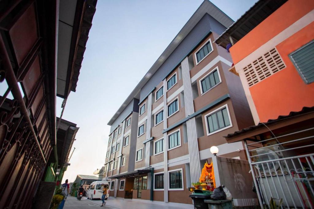 a building with a christmas tree in front of it at TP Residence เคหะร่มเกล้า in Lat Krabang