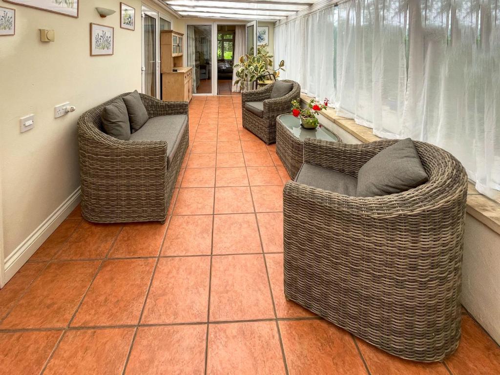 a living room with couches and chairs on a tile floor at Mimosa - Uk51224 in Swyre