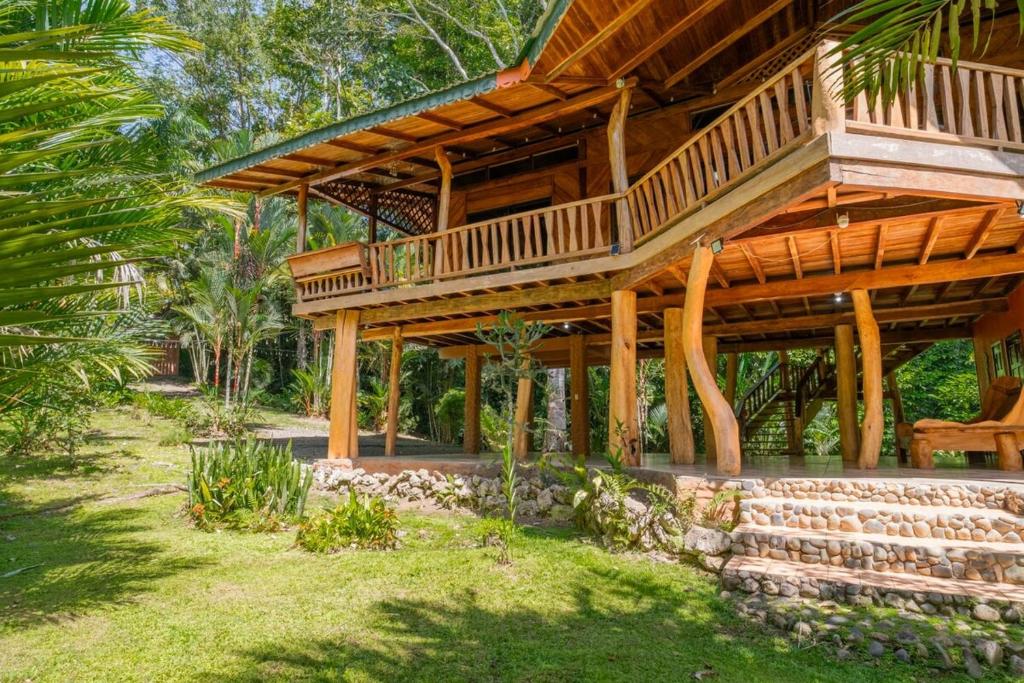 a large wooden house with a balcony on top at Charming Villa Surrounded by Nature Punta Uva in Puerto Viejo