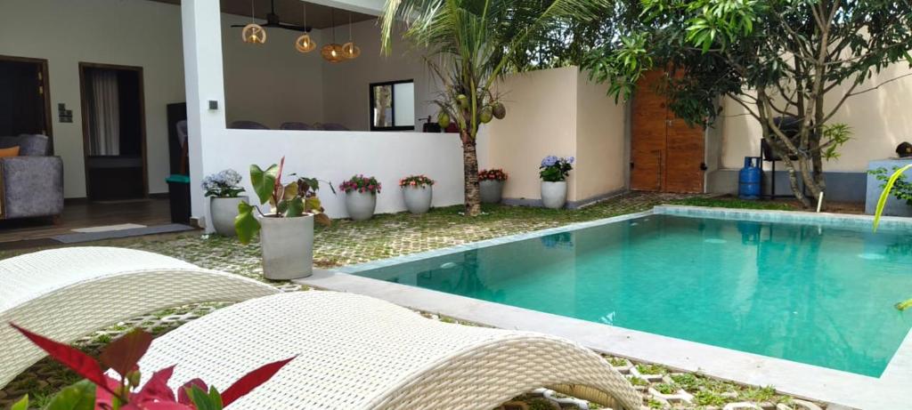 a swimming pool in the backyard of a house at Villa #1 in Unawatuna
