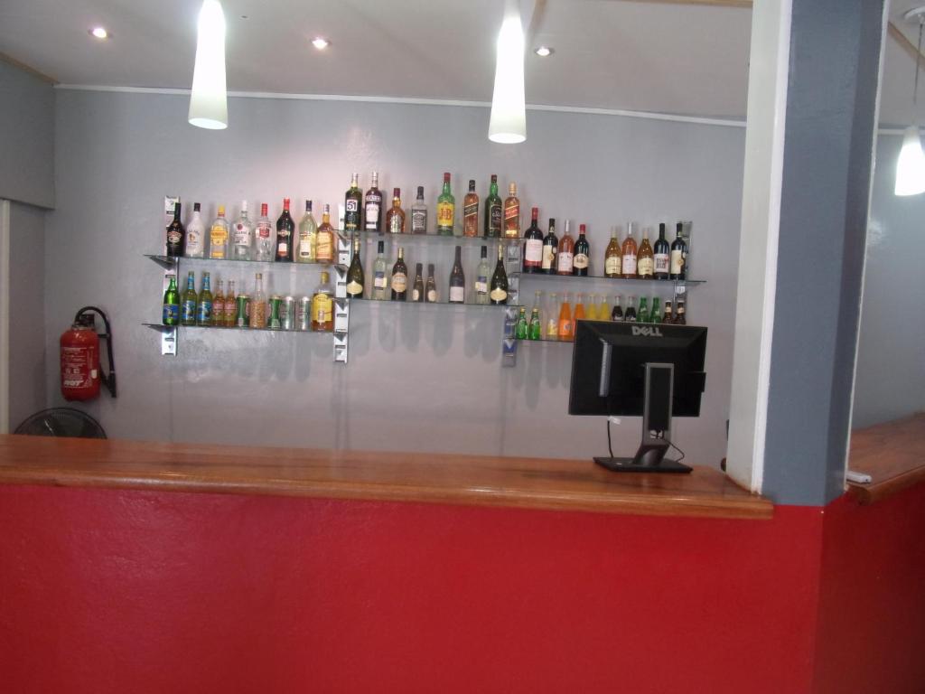 a bar with several bottles of alcohol on the wall at Melia Hotel in Saly Portudal