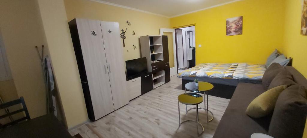 a small living room with a couch and a bed at Студио in Shumen