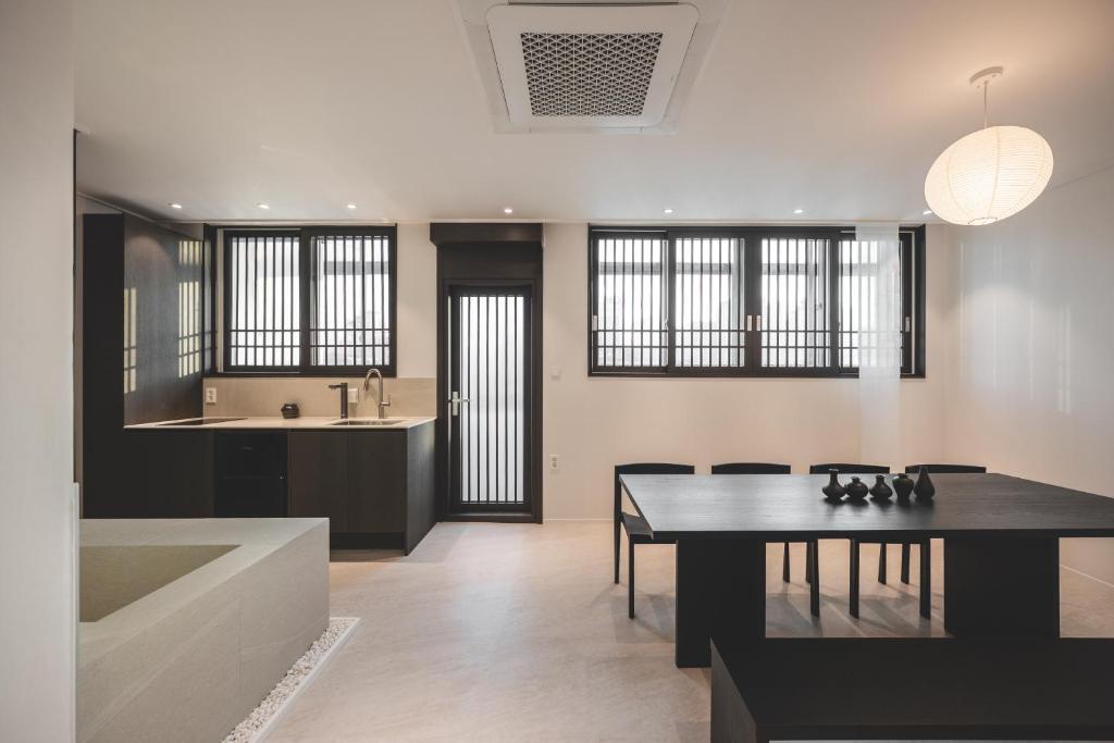 a kitchen and dining room with a table and a tub at GOYURe 고유리 in Seoul
