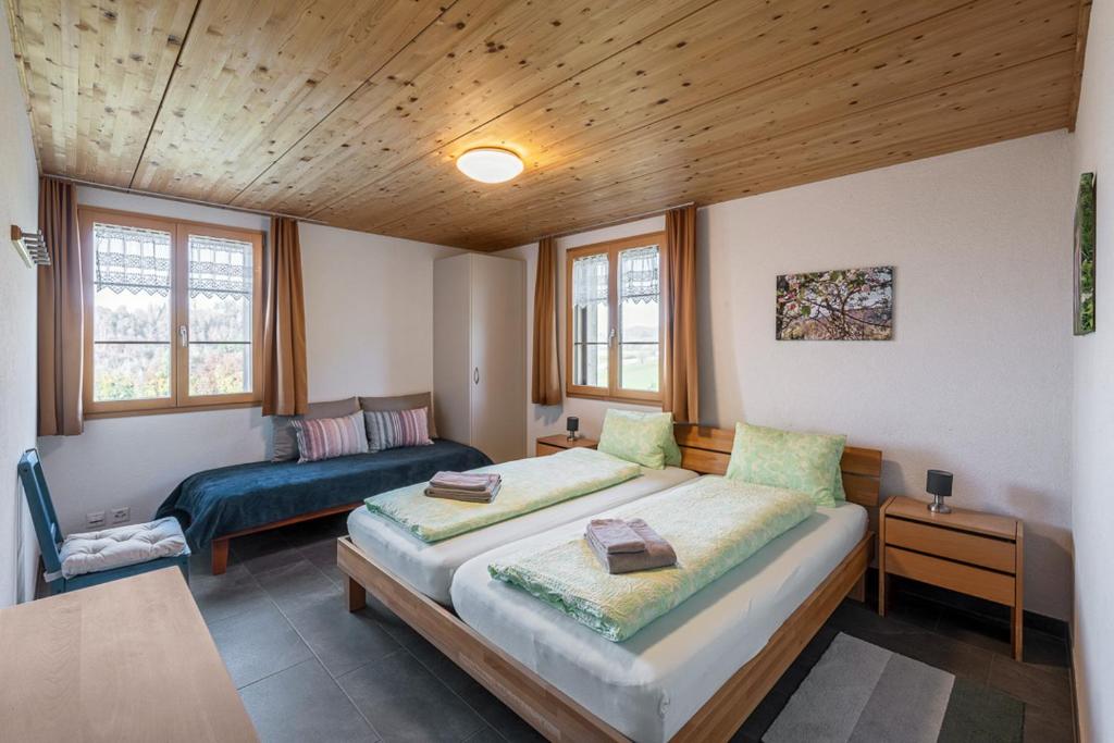 a bedroom with a bed and a couch in it at Bed and Breakfast Bauernhof Bättwil in Burgdorf