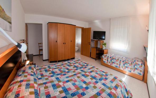 Postel nebo postele na pokoji v ubytování Albergo Alla Torre