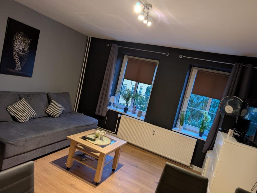 a living room with a couch and a table at Flensburg Zentrum 69 01 in Flensburg