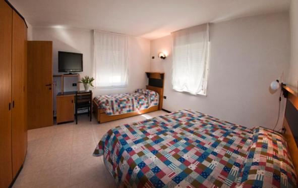 Postel nebo postele na pokoji v ubytování Albergo Alla Torre