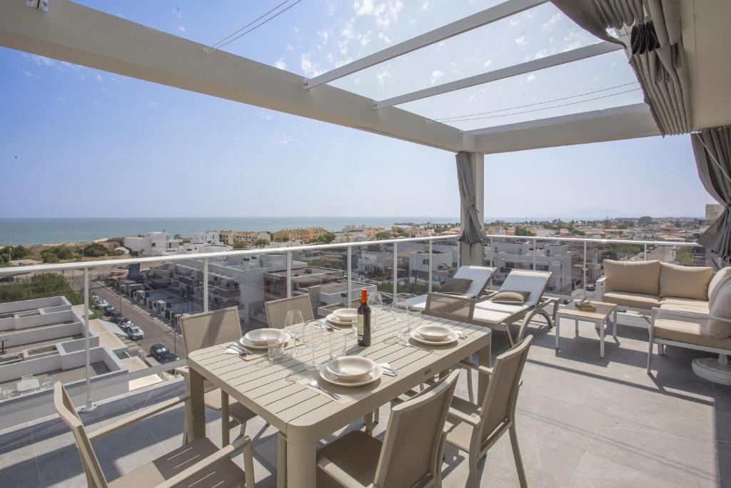 a dining room with a table and chairs on a balcony at AT Ponent VI in Oliva