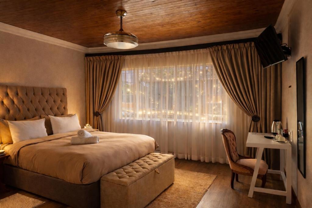 a bedroom with a large bed and a window at La Dukes Resort in Bushman Rock
