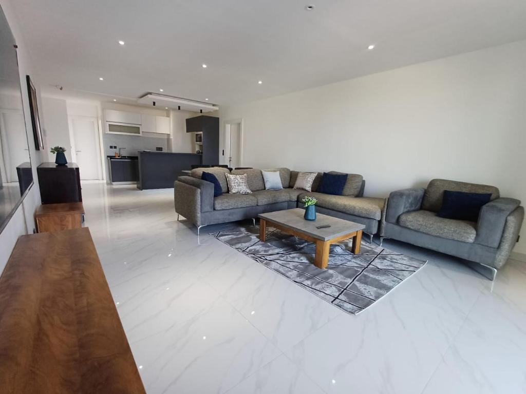 a living room with two couches and a coffee table at Ocean Waves Yoff Virage in Dakar