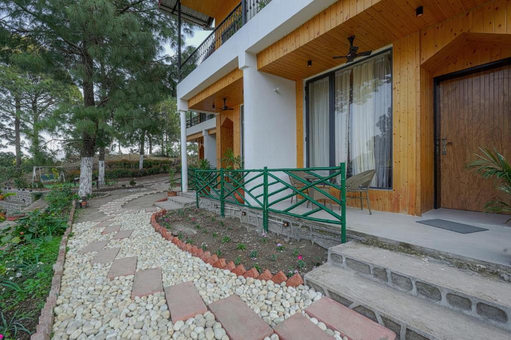 a house with a garden in front of it at ELIVAAS Signature Pine view resort in Sabāthu