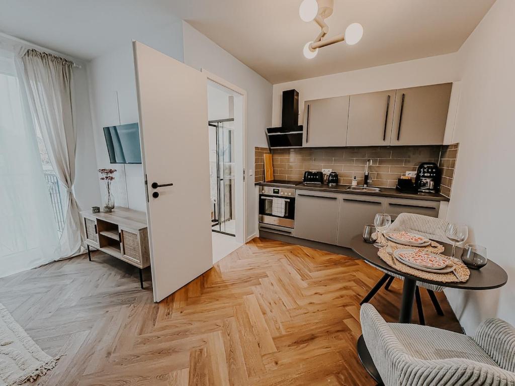 a kitchen with a table and a counter top at Batu Apartment in Viernheim