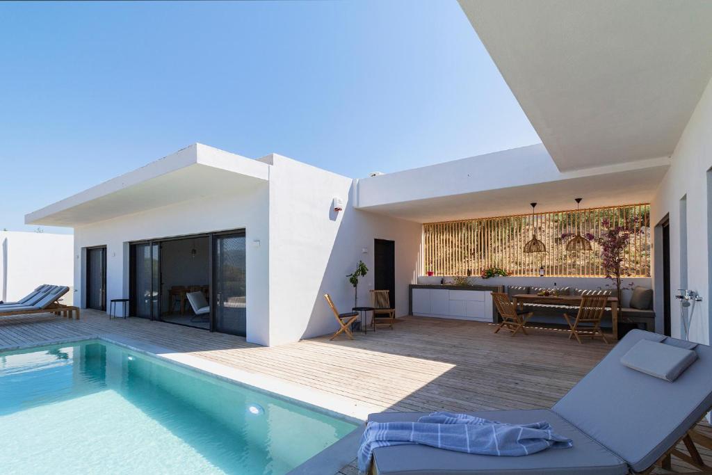 a villa with a swimming pool and a house at Villa Anna in Paleros