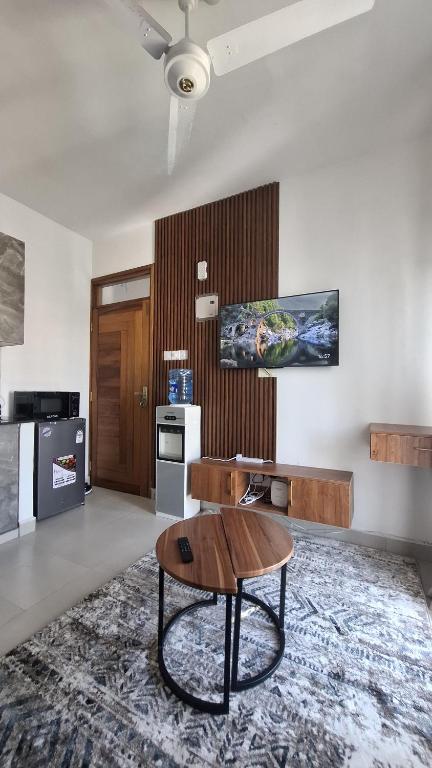 a living room with a coffee table and a kitchen at Bahari Home in Nyali