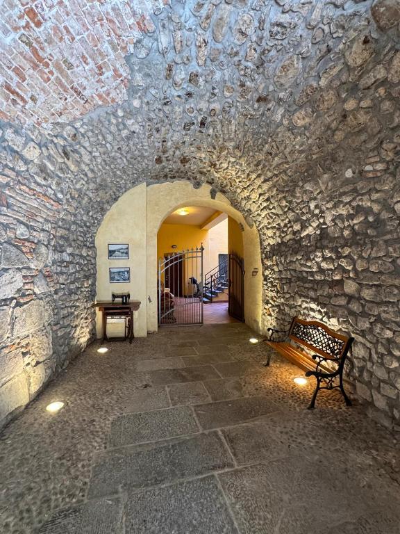 a tunnel with a bench in a stone wall at Centro Storico Suites Sarnico in Sarnico