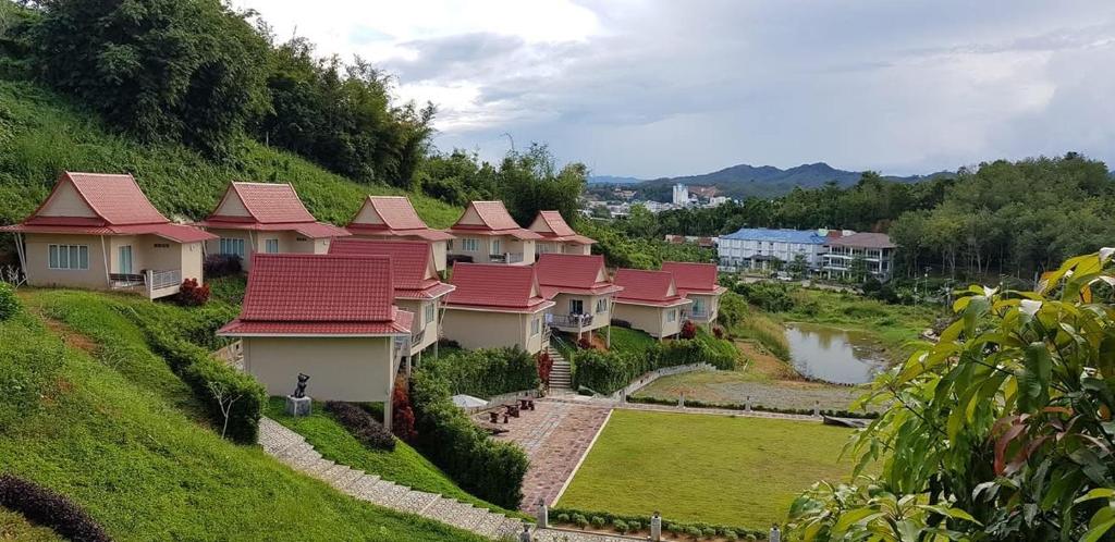 a row of houses with red roofs on a hill at Pupha&Sila Home Resort in Betong