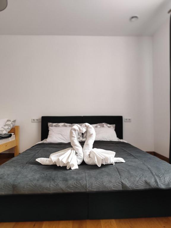 a towel animal is laying on a bed at Berryblossom Estate in Krosno