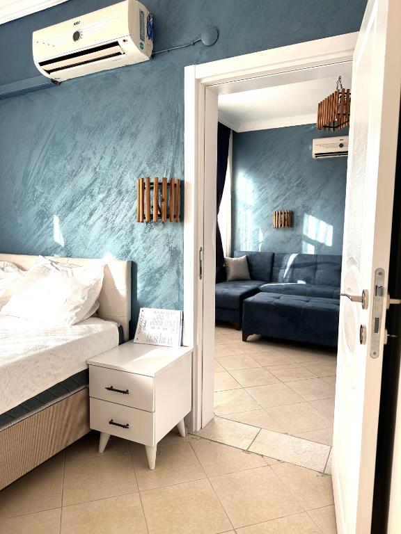 a bedroom with a bed and a couch at pH Ölüdeniz Suite in Fethiye