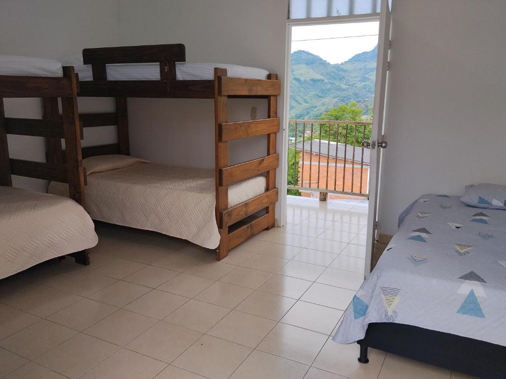a bedroom with two bunk beds and a balcony at Apartamento Rústico Moderno in Ruiosucio