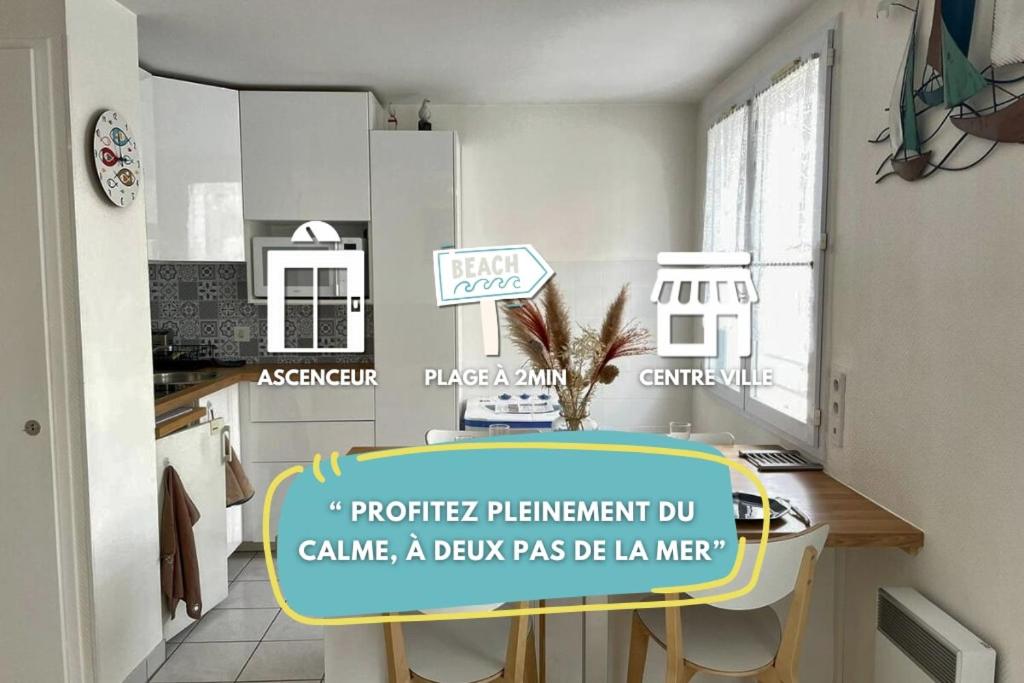a kitchen with a table with a sign on it at Le Studio du centre - 2-4p - 80 m de la plage in Les Sables-d'Olonne