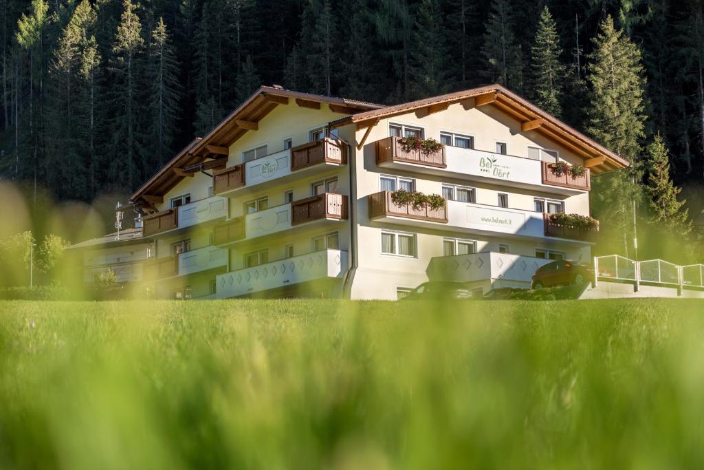 a building with balconies on the side of it at Garni Hotel Bel Vert in Selva di Val Gardena