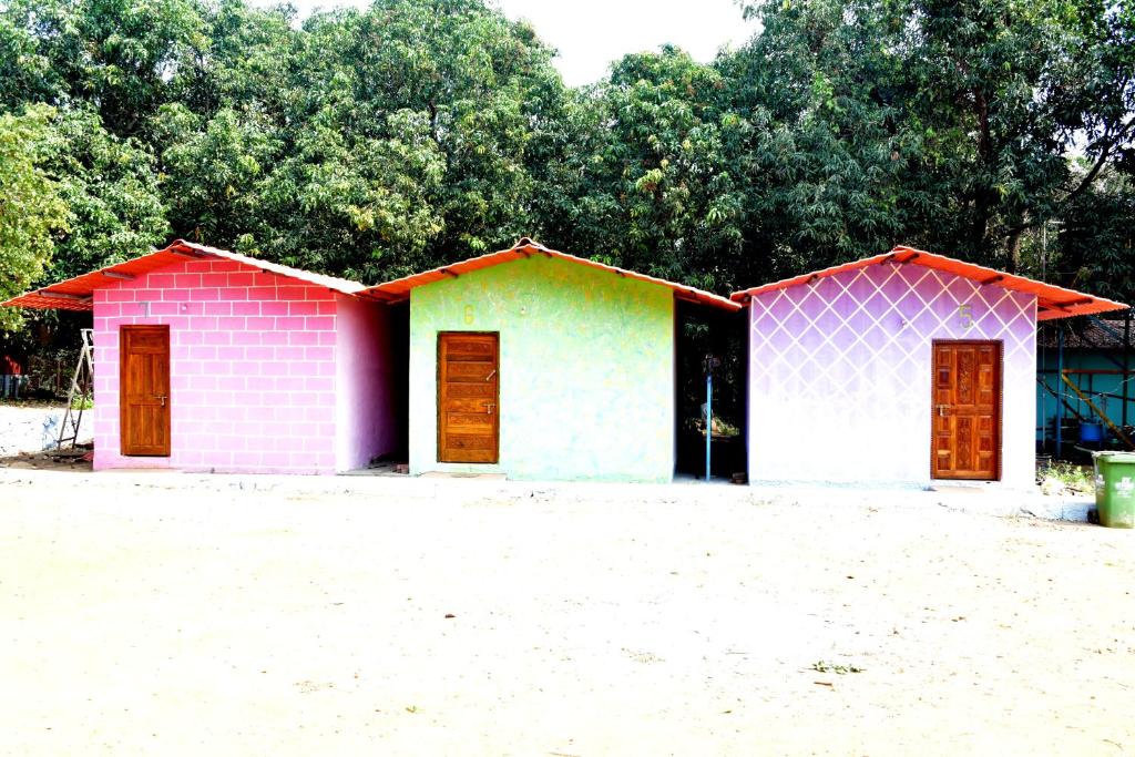 two houses painted in pink and green at Nivant Agro Experience in Gorhe