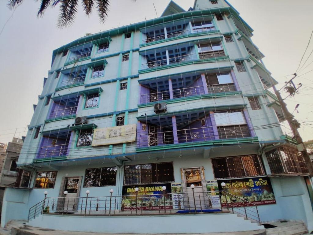 a tall blue building with balconies on it at Bhakta Bhawan in mayapur