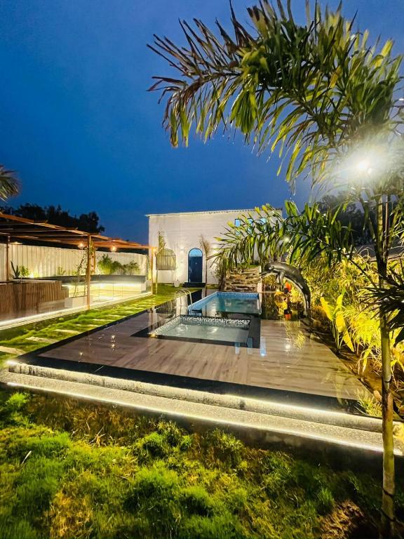 a house with a swimming pool in a yard at Greek House By Housiify in Gurgaon