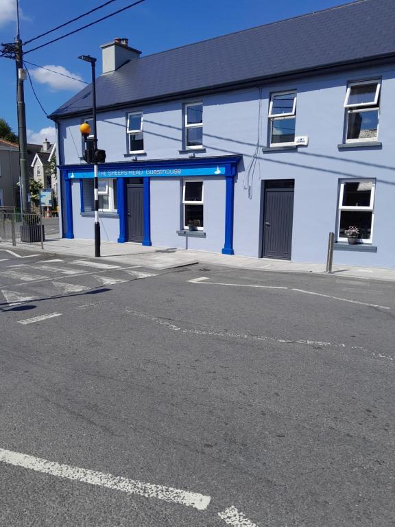 a blue building on the corner of a street at The Sheepshead Guesthouse in Durrus