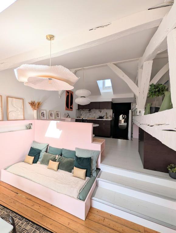 a living room with a white couch and stairs at Charmant cocon sous les toits de Bordeaux in Bordeaux