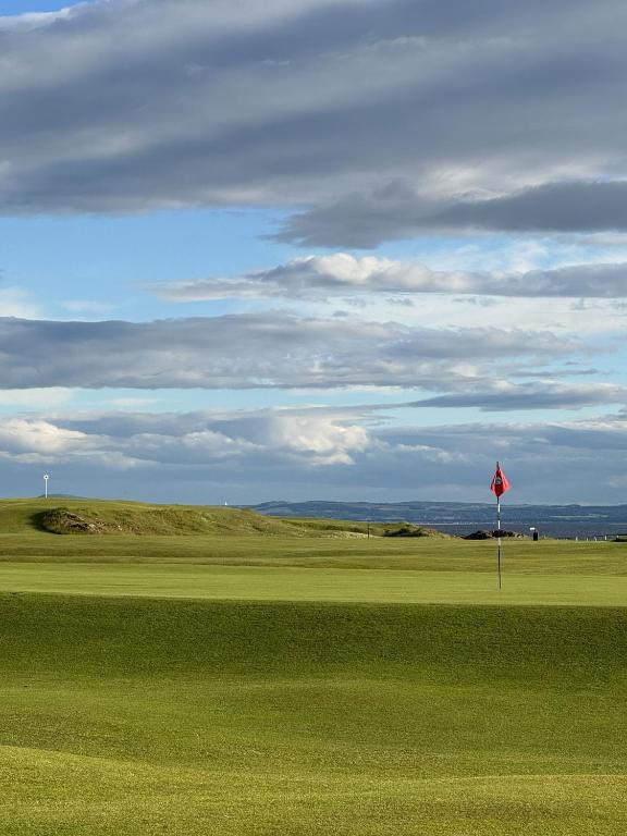 a red flag in the middle of a golf course at Westerham in North Berwick