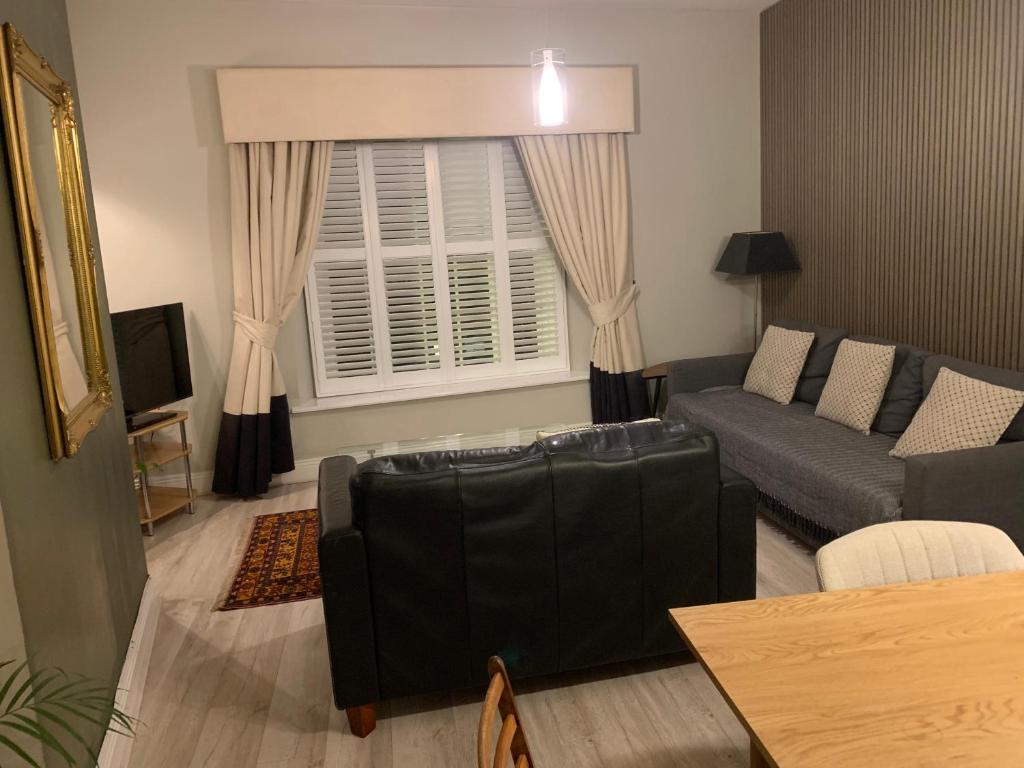 a living room with a couch and a window at Howth village apartment in Howth