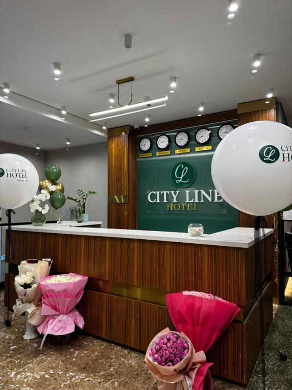 a city line hotel lobby with pink chairs and a counter at City Line HOTEL in Astana